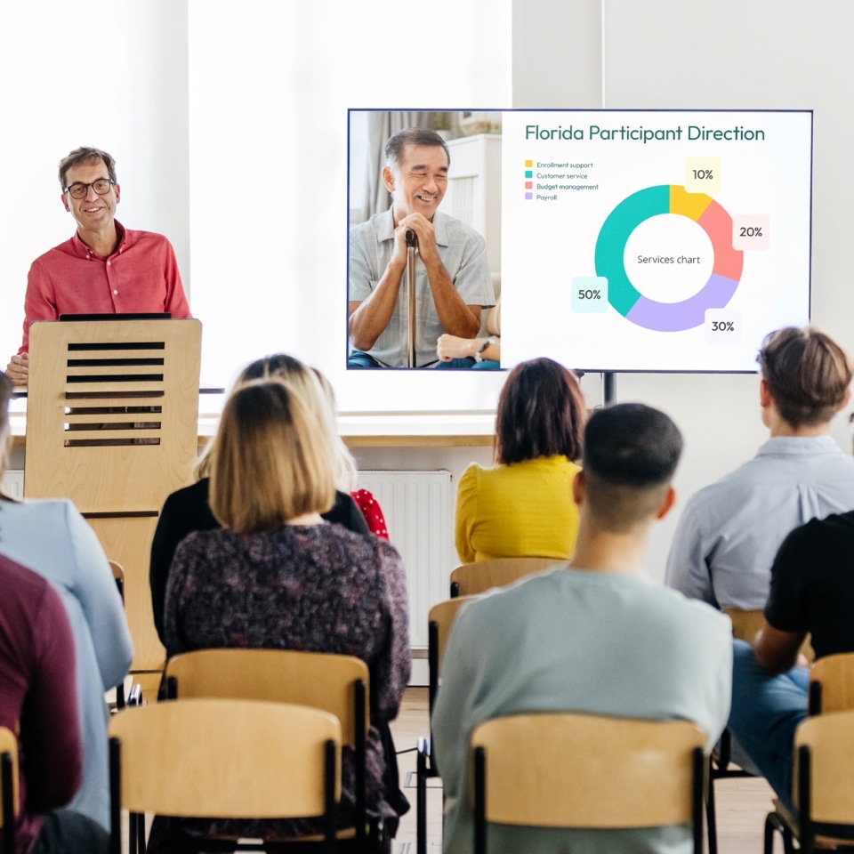 A young executive giving a lecture showing the presentation developed for PPL