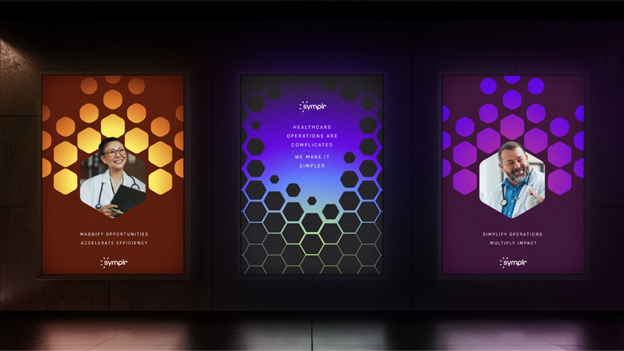 Three vibrant posters featuring various designs displayed on a black wall, promoting the brand 'symplr'