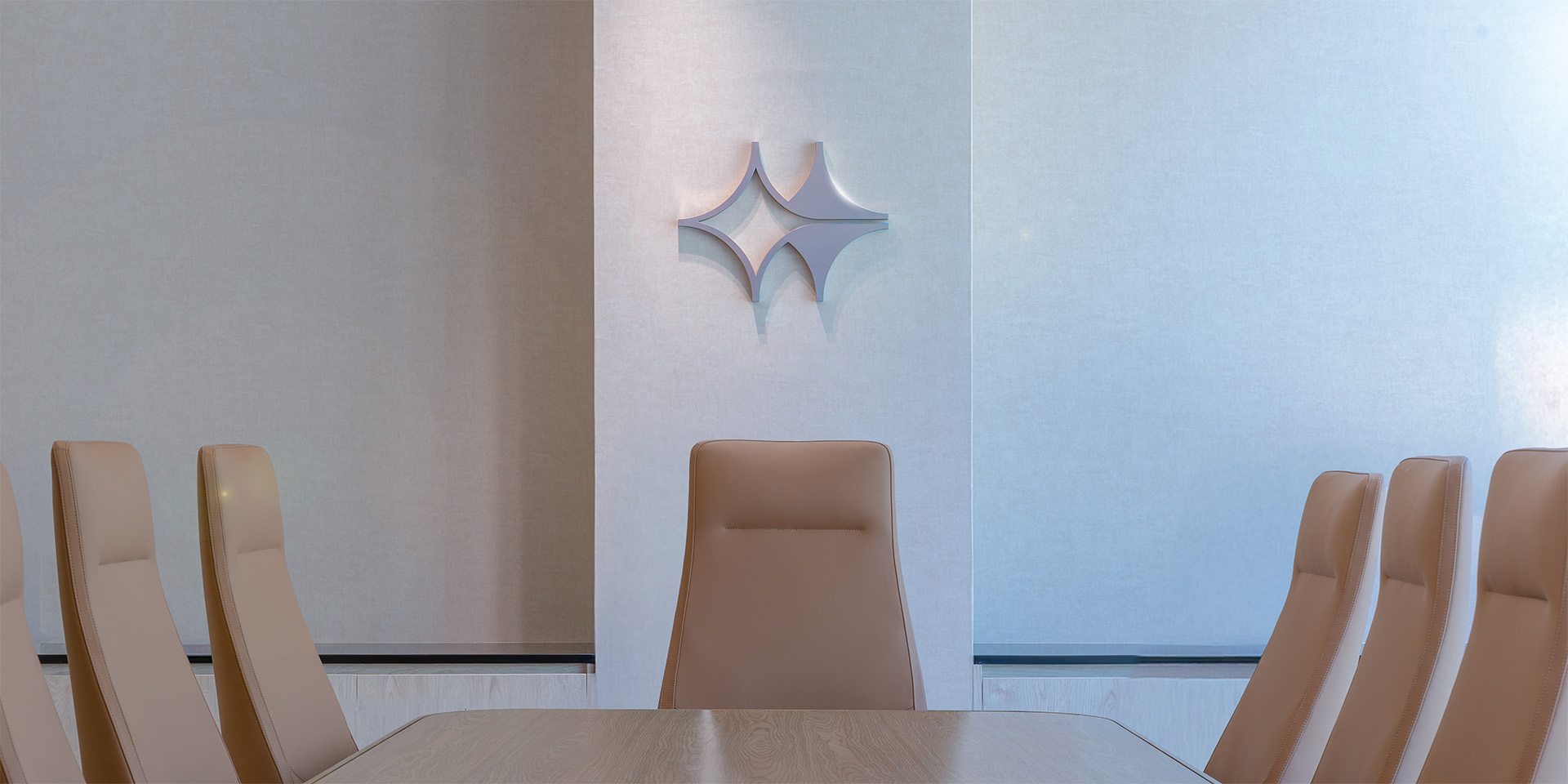 Modern Senwan board room with a display of the Senwan logo on the wall. The space is furnished with minimalist, sophisticated décor, providing a professional setting for strategic financial discussions.