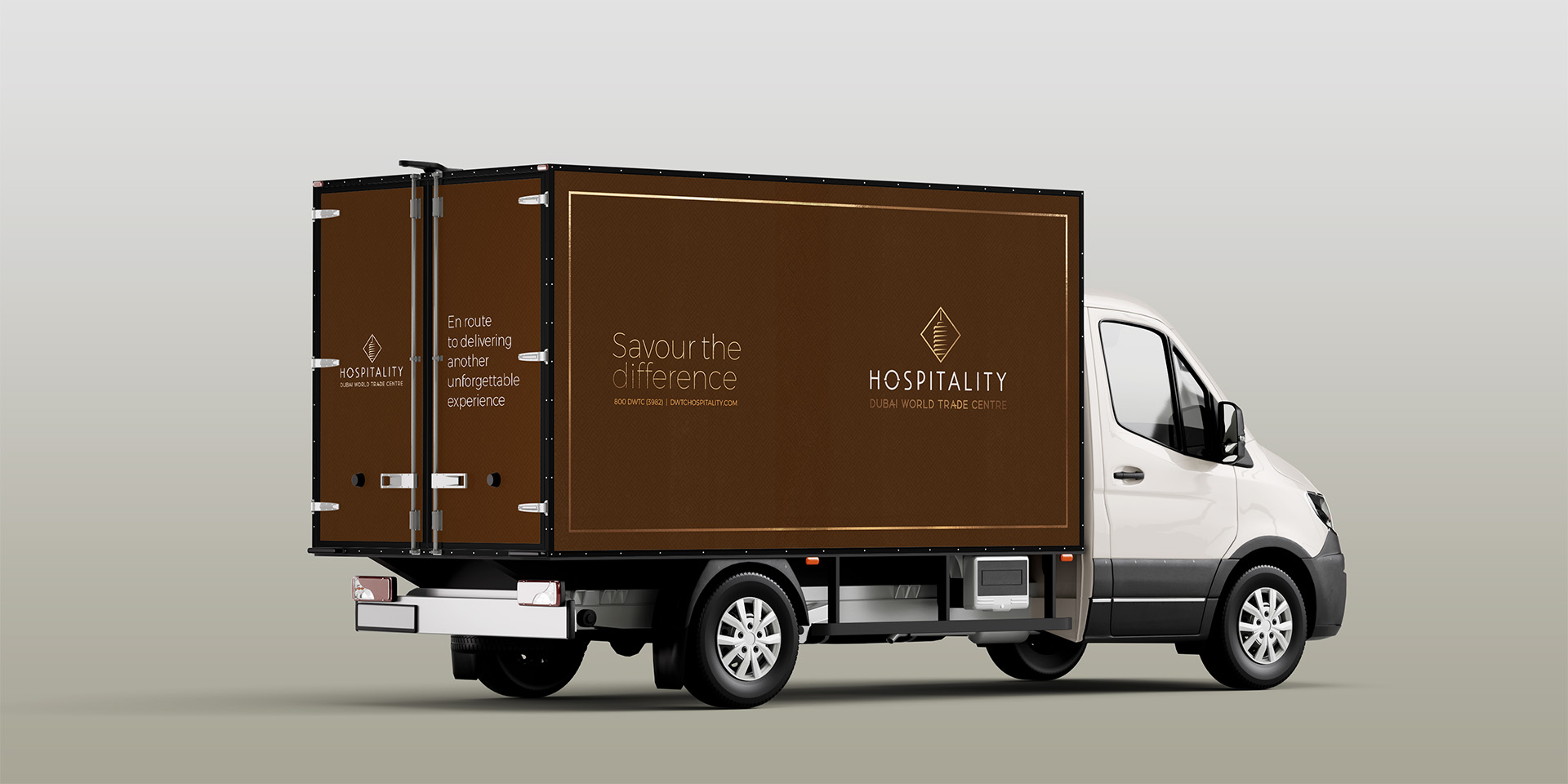 DWTC Hospitality-branded delivery vehicle showcasing the updated visual identity, logo with stylized cloche, and tagline “Savour The Difference”—emphasizing mobile catering, impeccable service, and connection to Dubai World Trade Centre.